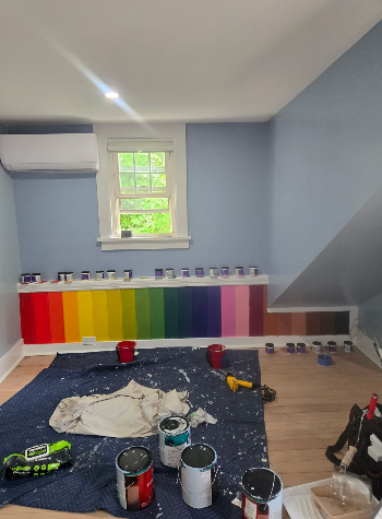 Color selection process with rainbow paint samples on wall