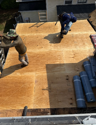 Professional crew installing plywood roof decking